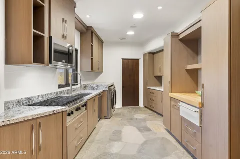 a spacious bathroom with a granite countertop sink mirror and bathtub