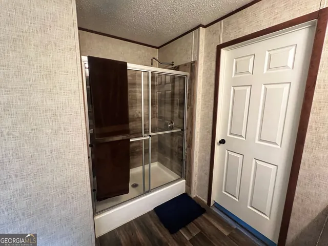 a bathroom with a glass door shower