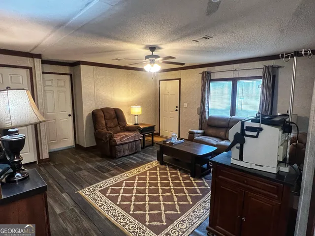 a living room with furniture a rug and a chandelier