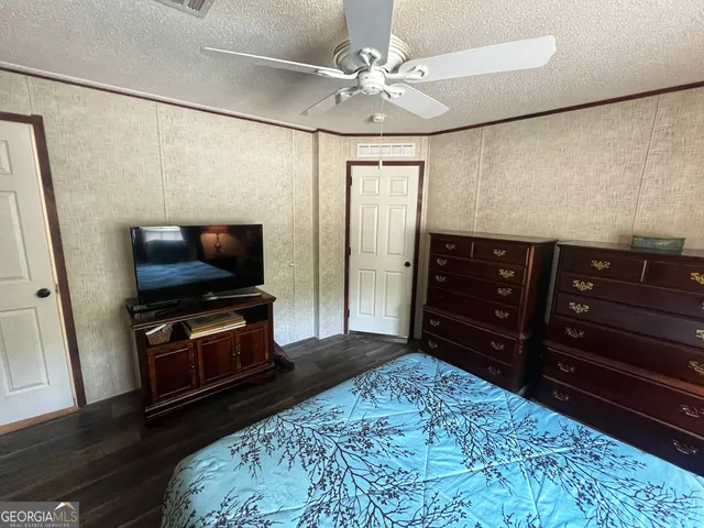 a bedroom with a bed and a television