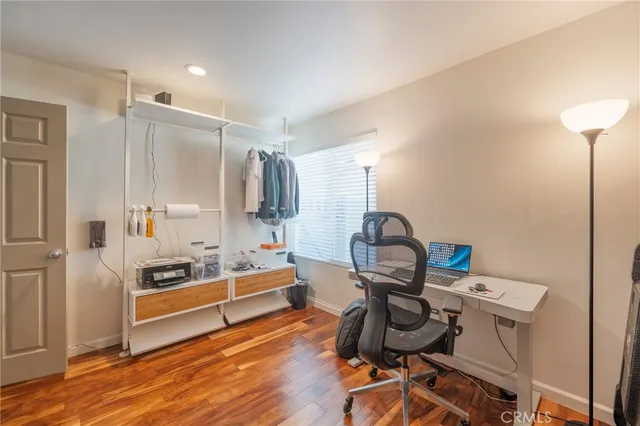 a view of a workspace with furniture and wooden floor