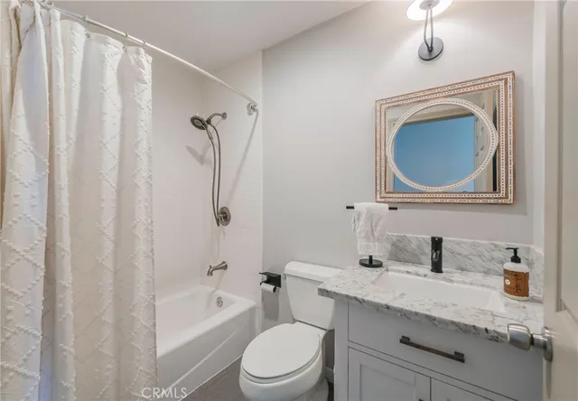 a bathroom with a toilet a sink and bathtub