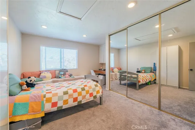 a bedroom with bed and a large window