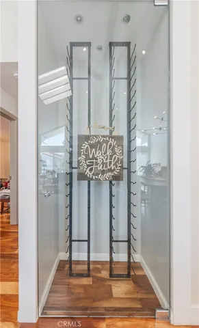 a bathroom with a glass shower door and a window
