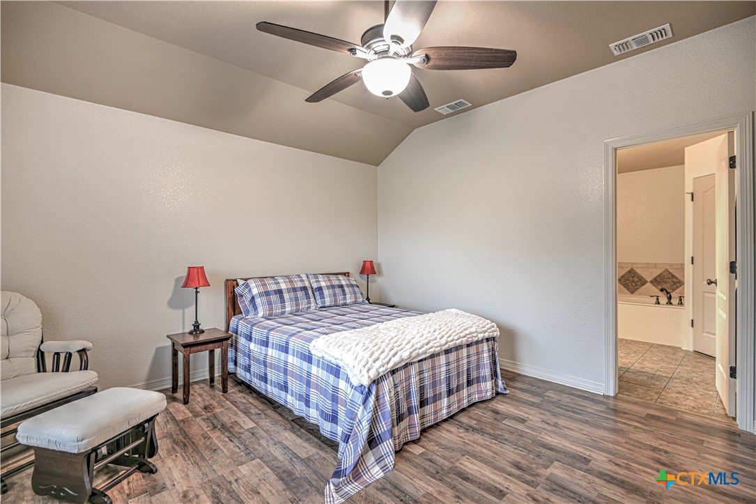 8405 Split Trl Cove Temple, TX 76502 - Photo 20 of 37 a bedroom with a bed and a chandelier