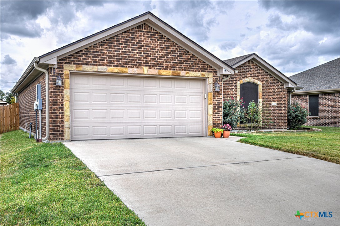 8405 Split Trl Cove Temple, TX 76502 - Photo 2 of 37 a front view of a house with a yard and garage