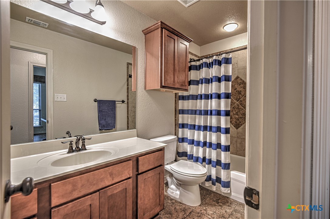 8405 Split Trl Cove Temple, TX 76502 - Photo 24 of 37 a bathroom with a sink toilet vanity and shower