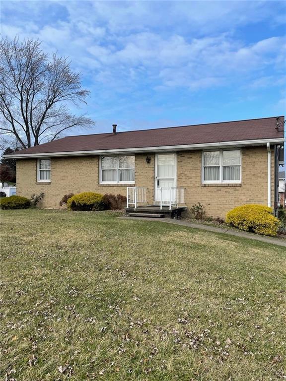 1409 Mission Road Latrobe, PA 15650 - Photo 2 of 8 a front view of house with yard space and outdoor seating