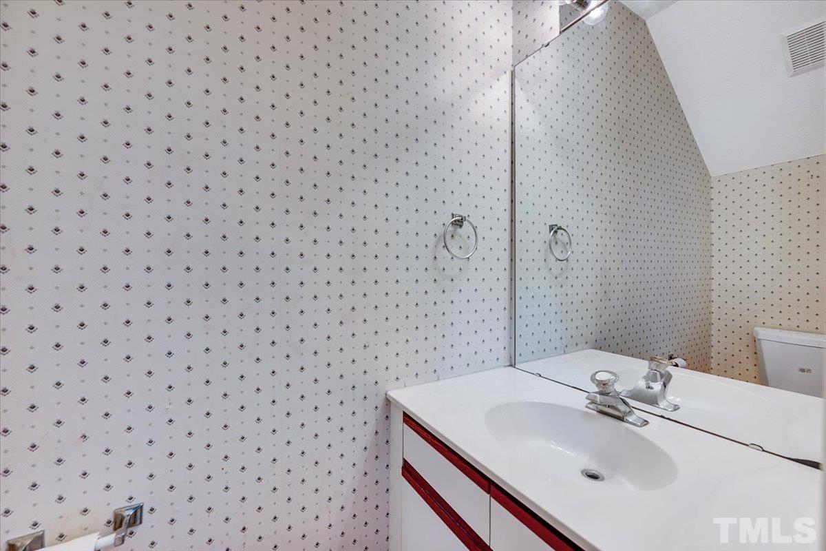4003 Kettering Drive Durham, NC 27713 - Photo 15 of 28 a bathroom with a sink and a mirror