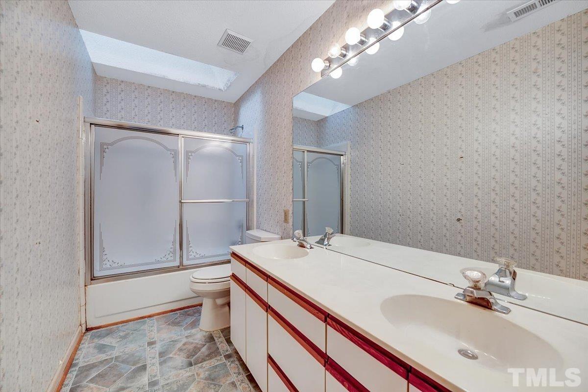4003 Kettering Drive Durham, NC 27713 - Photo 18 of 28 a bathroom with a double vanity sink mirror and shower