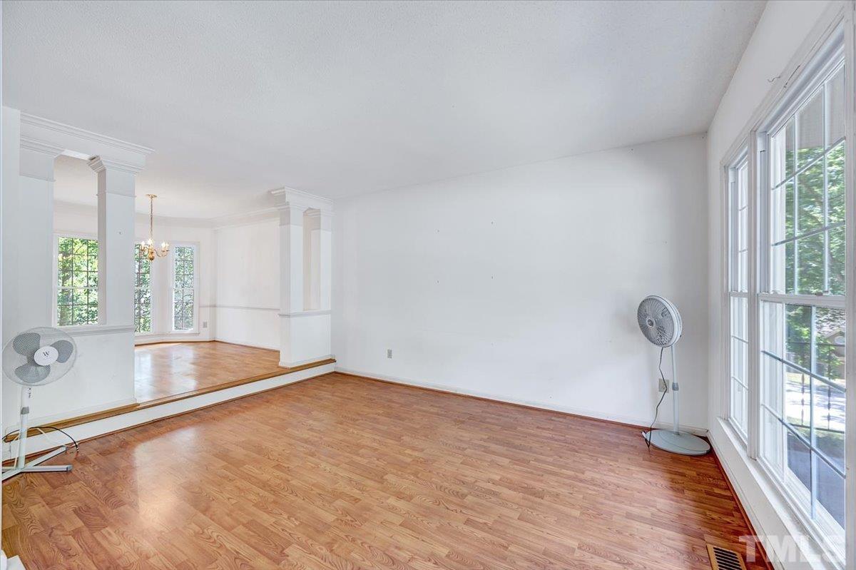 4003 Kettering Drive Durham, NC 27713 - Photo 4 of 28 an empty room with wooden floor and windows