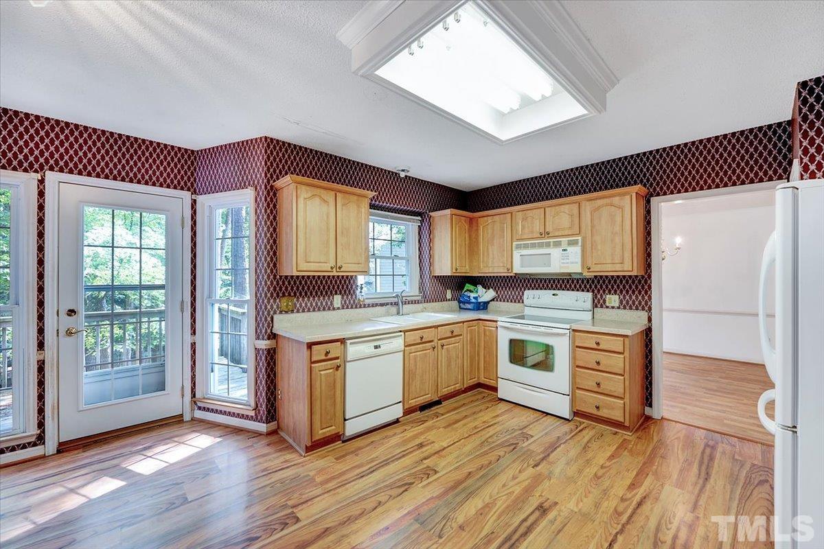 4003 Kettering Drive Durham, NC 27713 - Photo 8 of 28 a kitchen with stainless steel appliances granite countertop a stove a sink and a refrigerator