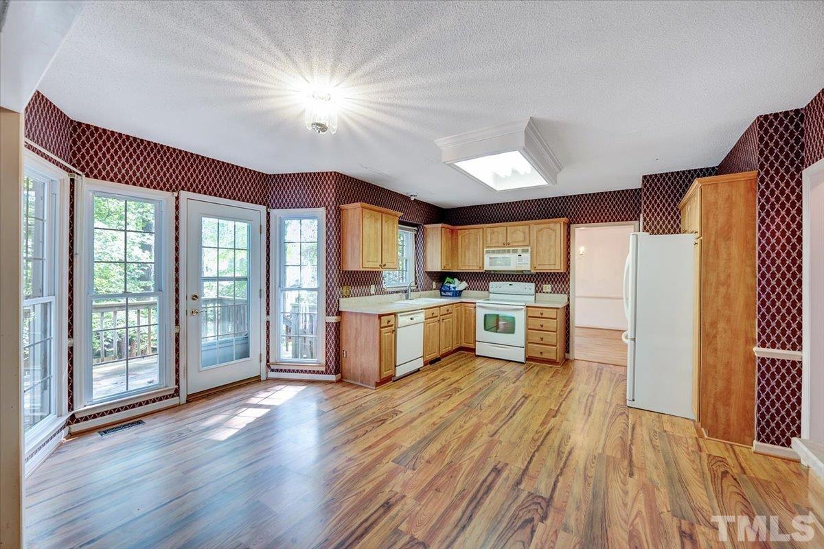 4003 Kettering Drive Durham, NC 27713 - Photo 9 of 28 a large kitchen with a large window a sink and stainless steel appliances