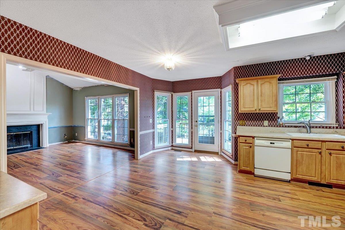 4003 Kettering Drive Durham, NC 27713 - Photo 10 of 28 a view of an empty room with window wooden floor and kitchen view