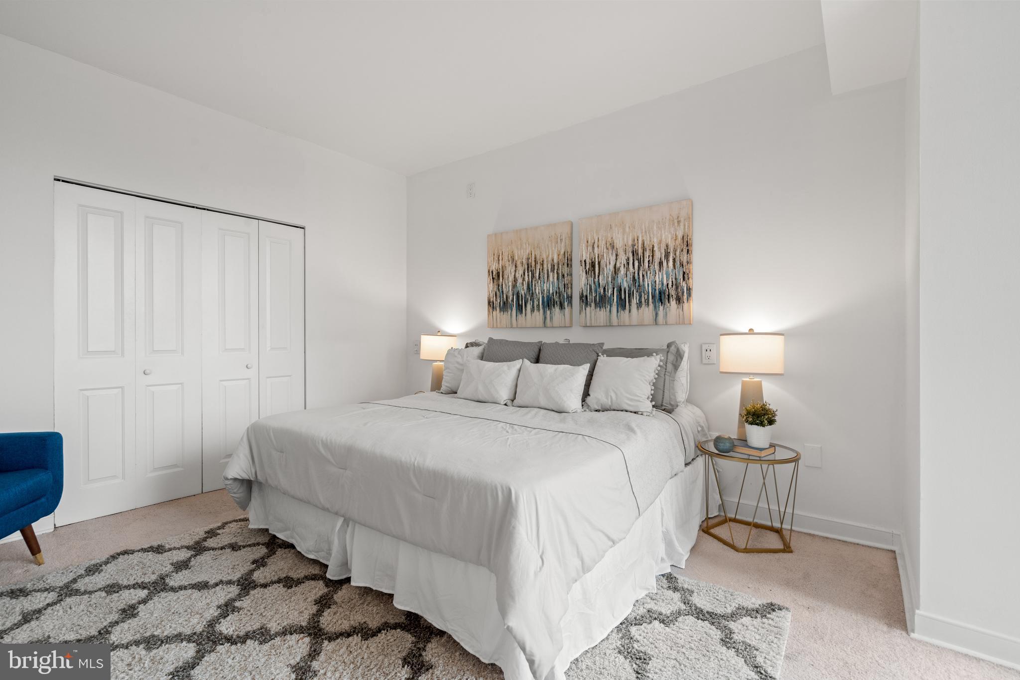 955 26th Street Northwest, Unit 707 Washington, DC 20037 - Photo 13 of 26 a bedroom with a bed and a painting on the wall