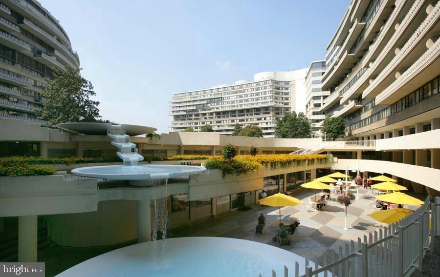 955 26th Street Northwest, Unit 707 Washington, DC 20037 - Photo 24 of 26 a view of a swimming pool with outdoor seating and plants