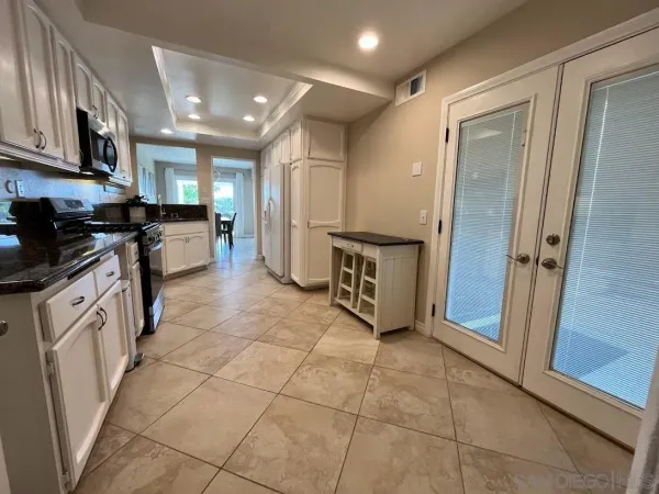 a large kitchen with a stove a refrigerator and a sink