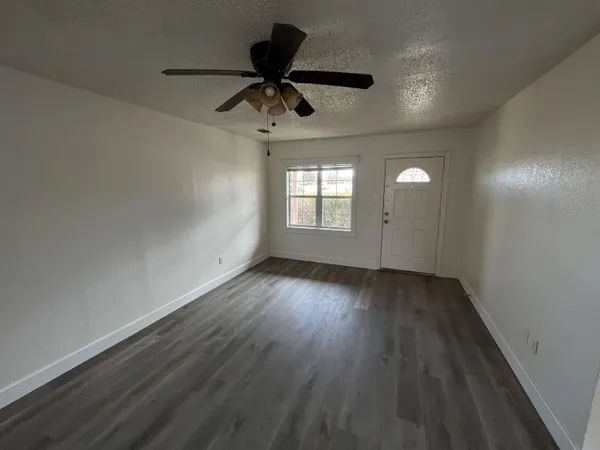 wooden floor in an empty room with a window
