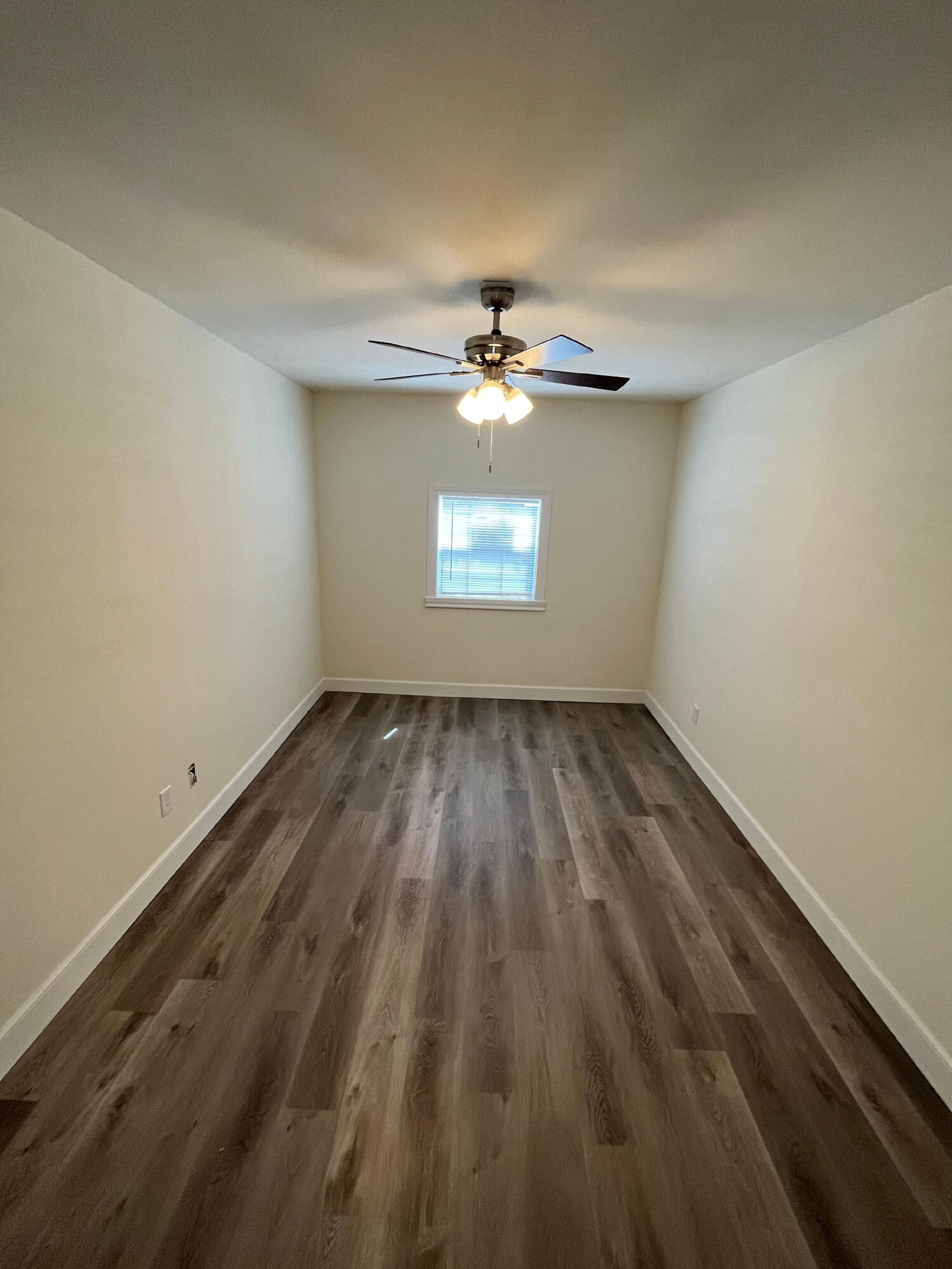 3404 30th Street Lubbock, TX 79410 - Photo 7 of 13 wooden floor in an empty room with a window