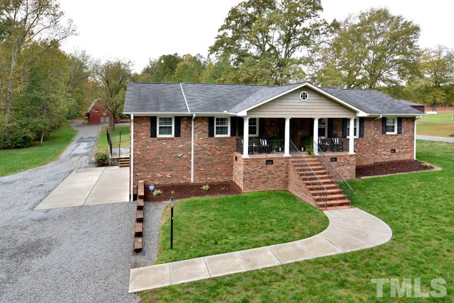 2260 Sanders Road Stem, NC 27581 - Photo 1 of 30 front view of a house with a yard