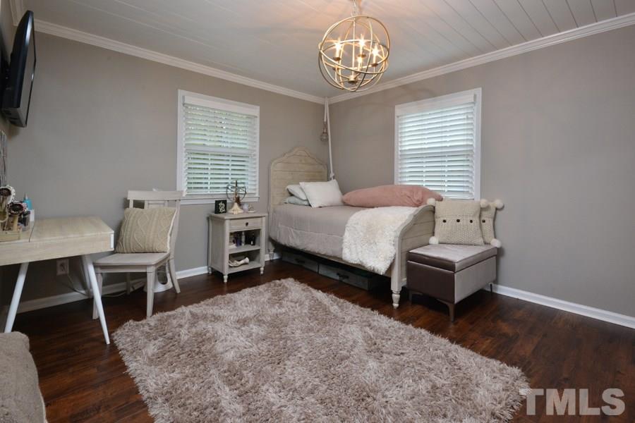 2260 Sanders Road Stem, NC 27581 - Photo 14 of 30 a spacious bedroom with a bed and a table in it
