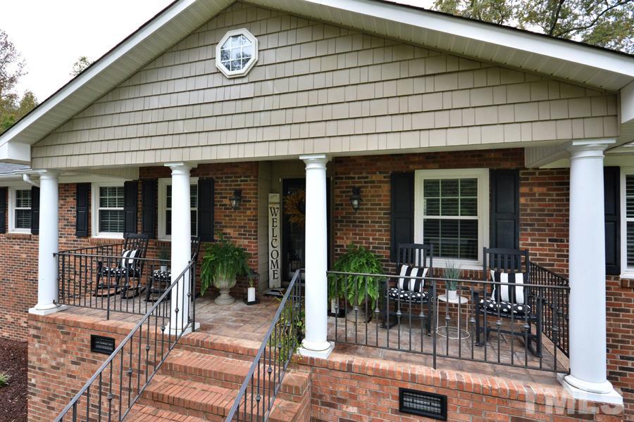 2260 Sanders Road Stem, NC 27581 - Photo 3 of 30 a front view of a house with outdoor seating