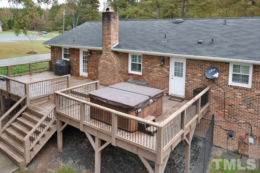 2260 Sanders Road Stem, NC 27581 - Photo 21 of 30 a view of a house with backyard and deck
