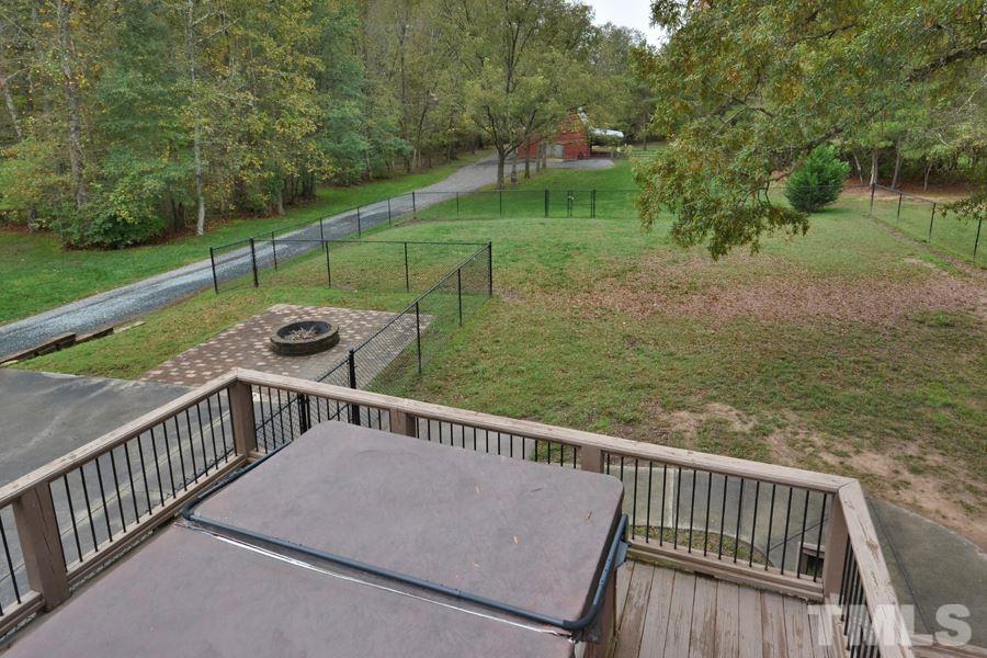 2260 Sanders Road Stem, NC 27581 - Photo 23 of 30 a view of a wooden deck with golf course