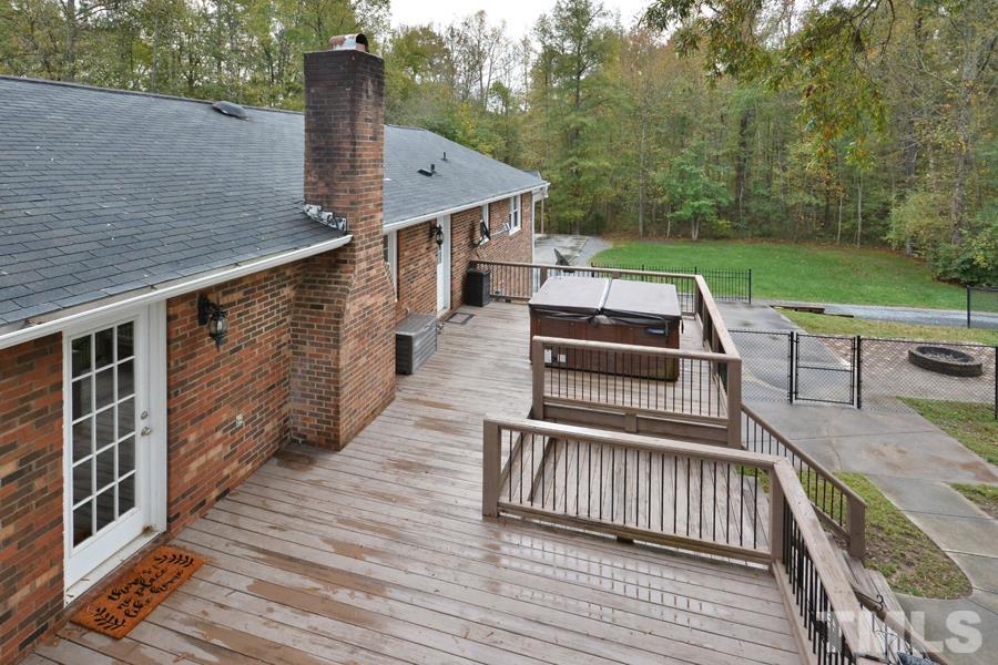 2260 Sanders Road Stem, NC 27581 - Photo 24 of 30 a view of a deck with wooden floor and fence