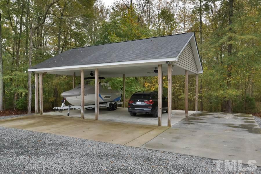 2260 Sanders Road Stem, NC 27581 - Photo 25 of 30 a view of a patio with table and chairs under an umbrella