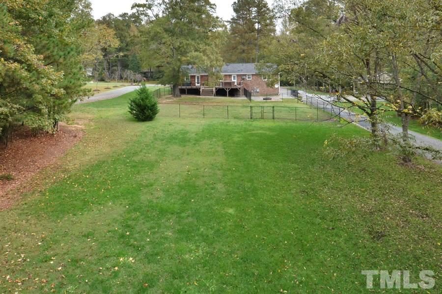 2260 Sanders Road Stem, NC 27581 - Photo 26 of 30 a backyard of a house with table and chairs