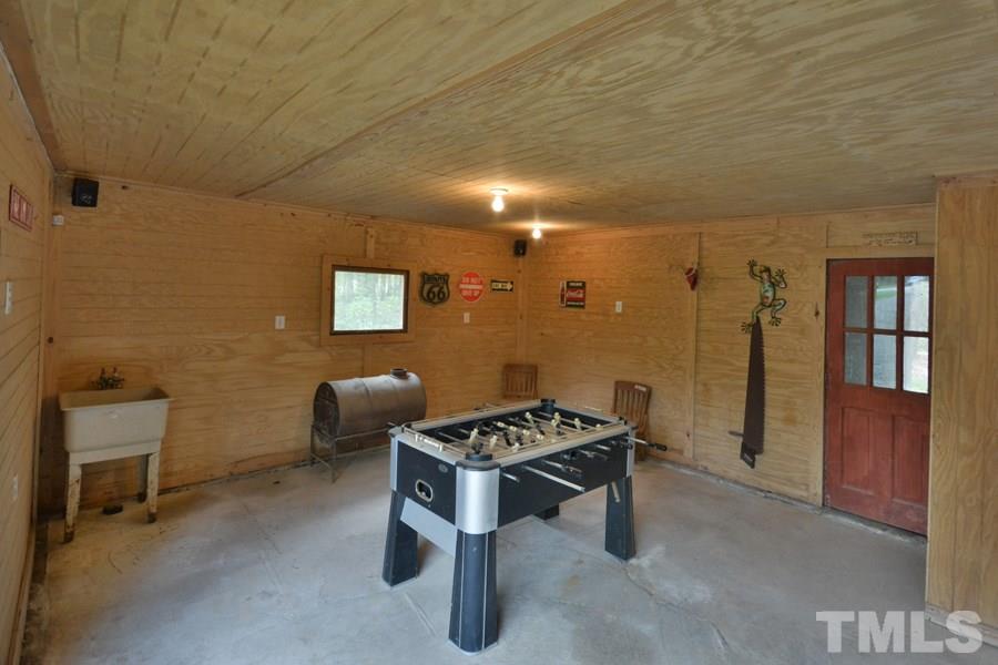 2260 Sanders Road Stem, NC 27581 - Photo 28 of 30 a backyard of a house with couches table and chairs