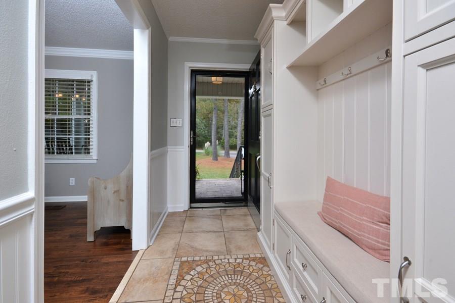 2260 Sanders Road Stem, NC 27581 - Photo 4 of 30 a hallway with front door wooden floor and windows