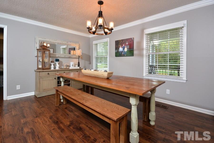 2260 Sanders Road Stem, NC 27581 - Photo 5 of 30 a room with a table chairs and windows