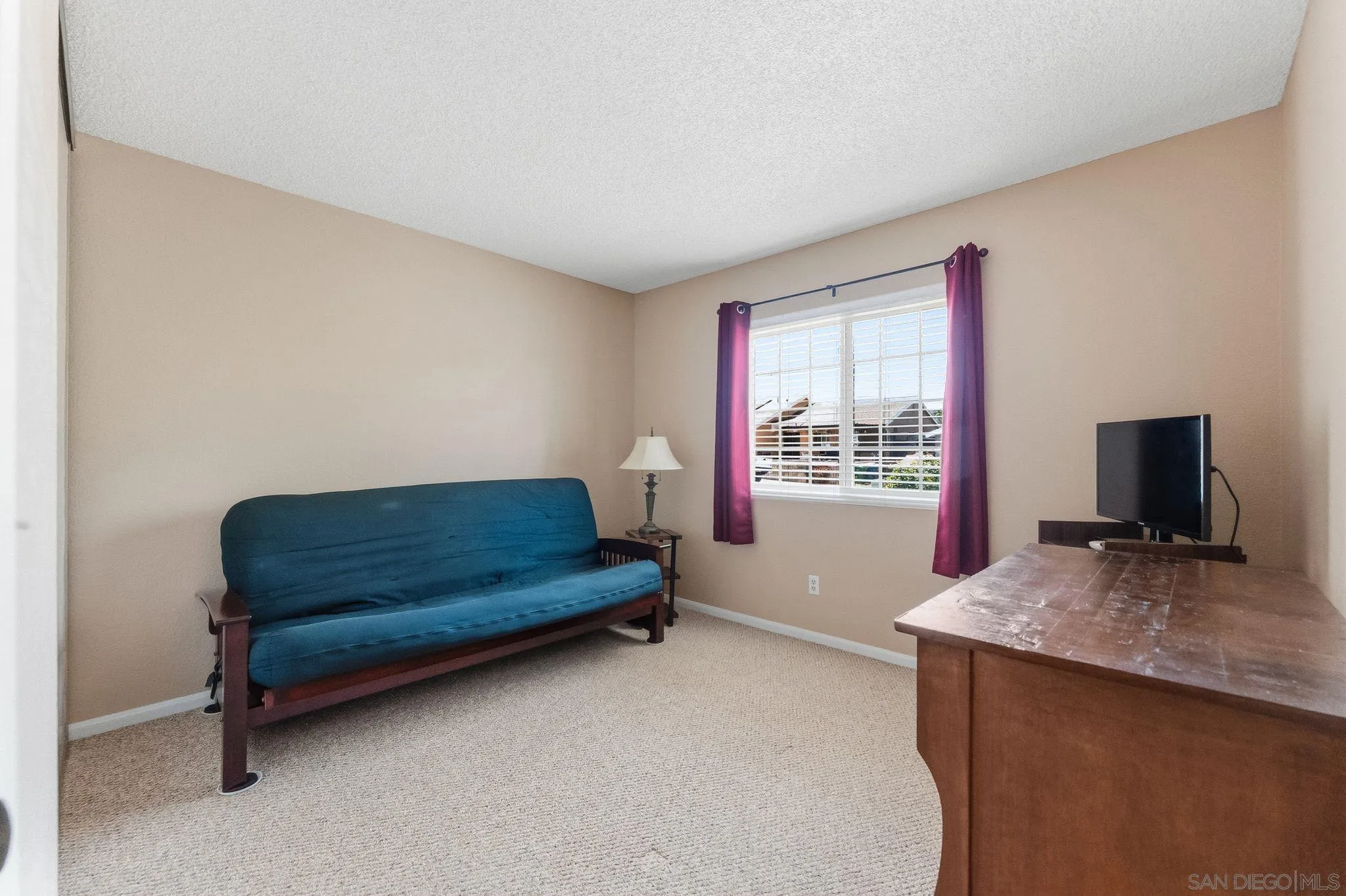 10565 Strathmore Drive Santee, CA 92071 - Photo 32 of 59 a bedroom with a bed and a flat screen tv