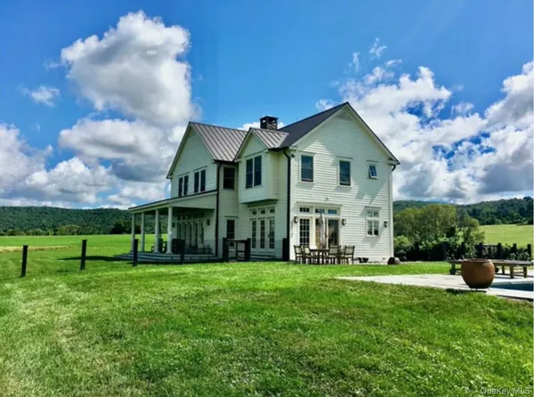 a front view of house with yard and green space