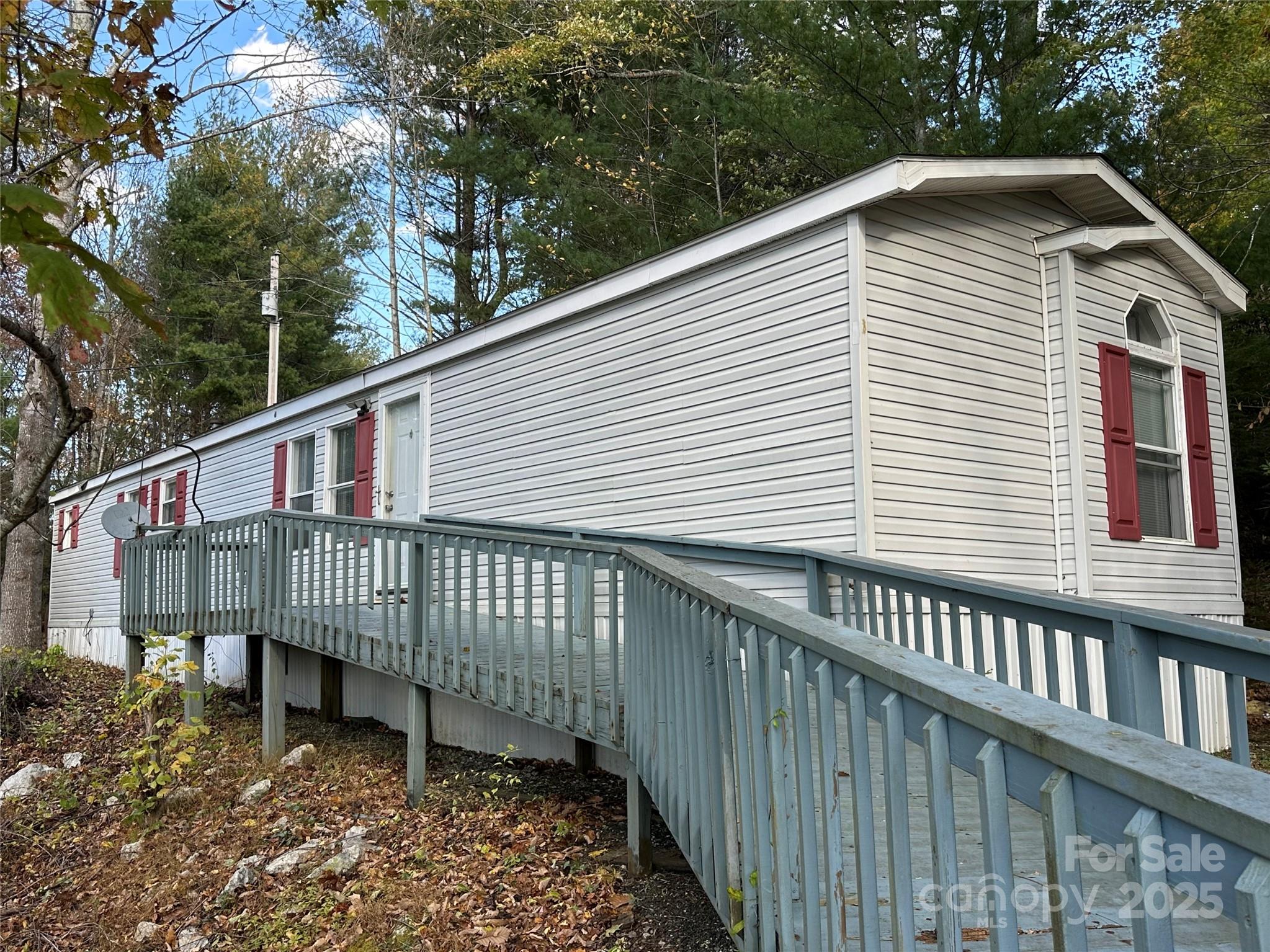 a view of a house with a yard and a deck