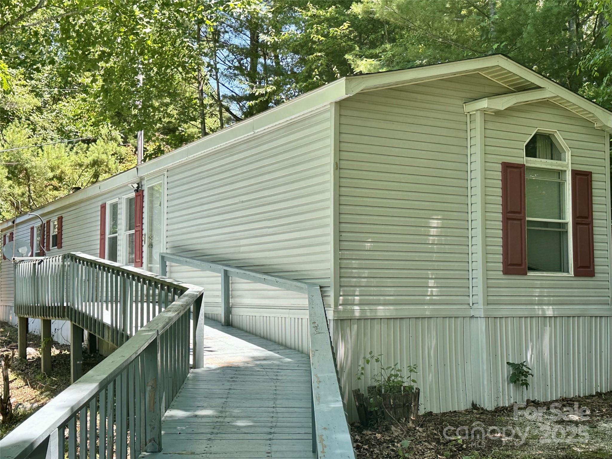 572 Blue Rdg Parkway Spruce Pine, NC 28777 - Photo 31 of 38 a side view of a house with backyard and deck