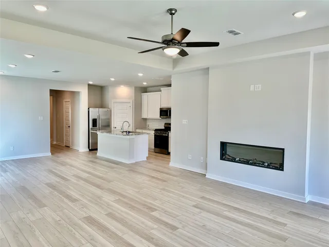 a view of a kitchen with a microwave and a ceiling fan