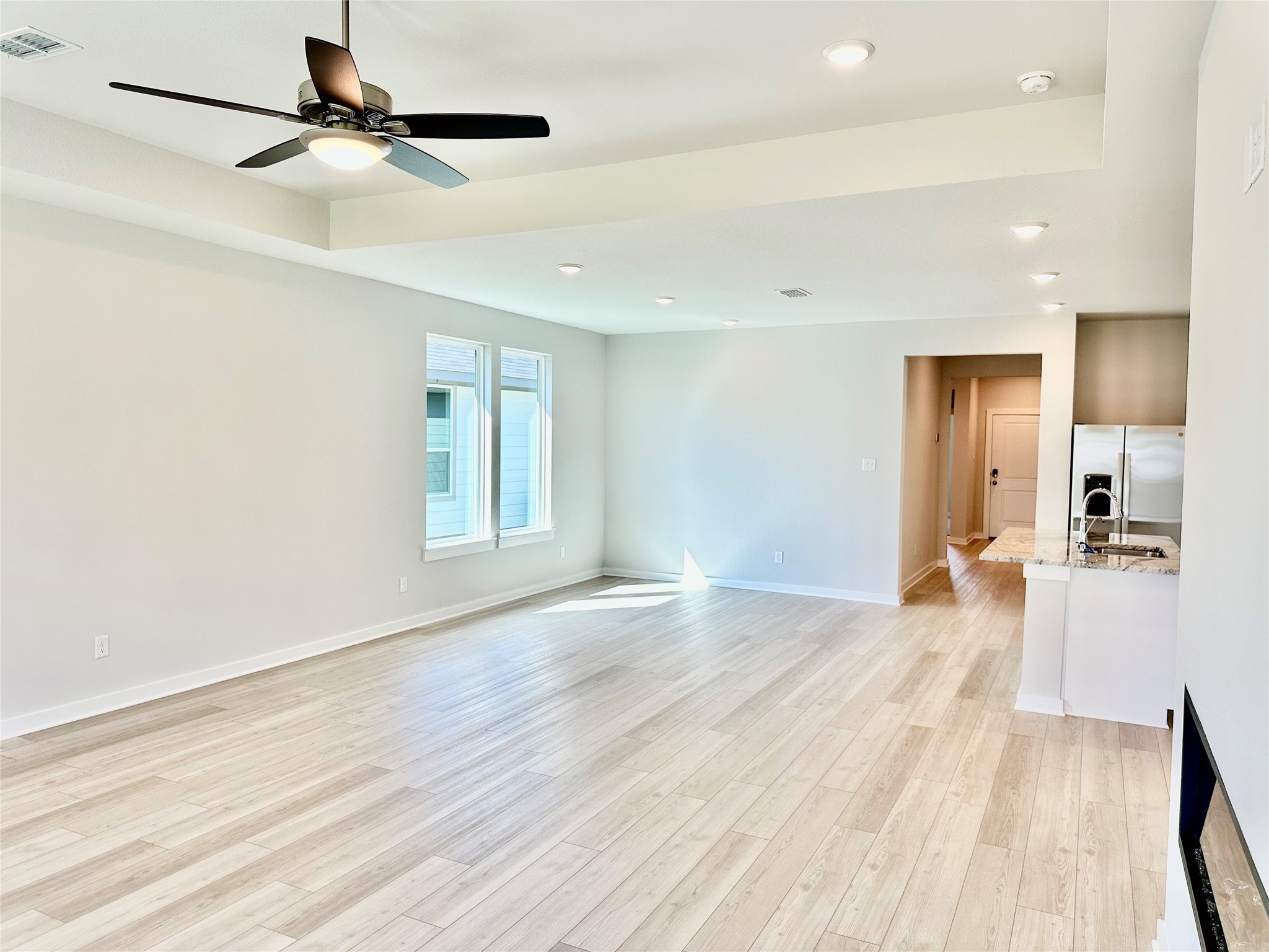 21619 Flannel Bush Lane Cypress, TX 77433 - Photo 17 of 34 a view of a room with wooden floor and a ceiling fan