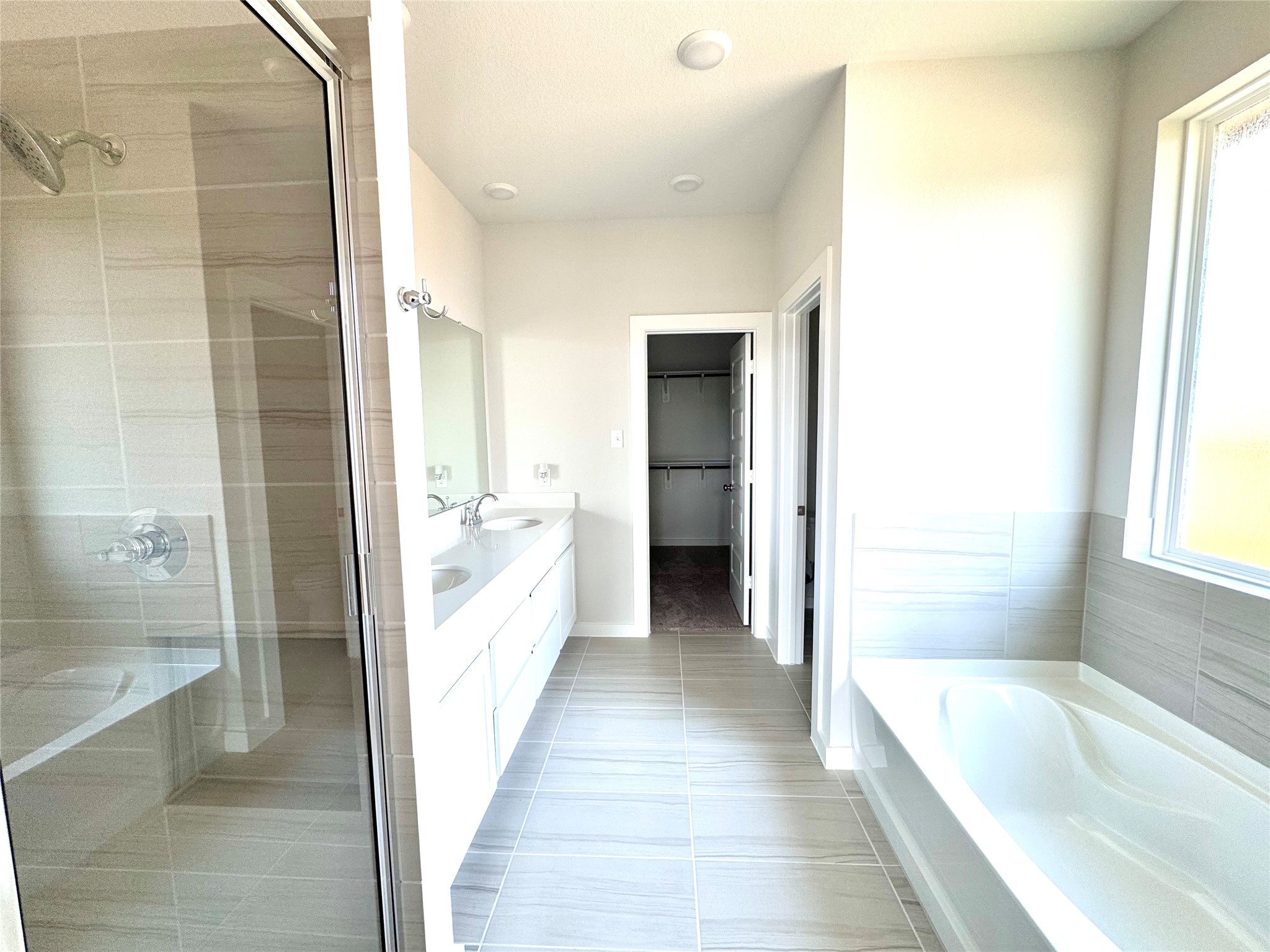 21619 Flannel Bush Lane Cypress, TX 77433 - Photo 22 of 34 a bathroom with a granite countertop tub shower and sink