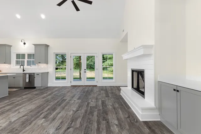 a view of a kitchen with a sink dishwasher and a fireplace