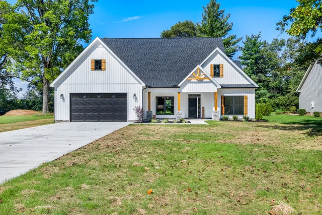 a front view of house with yard and green space