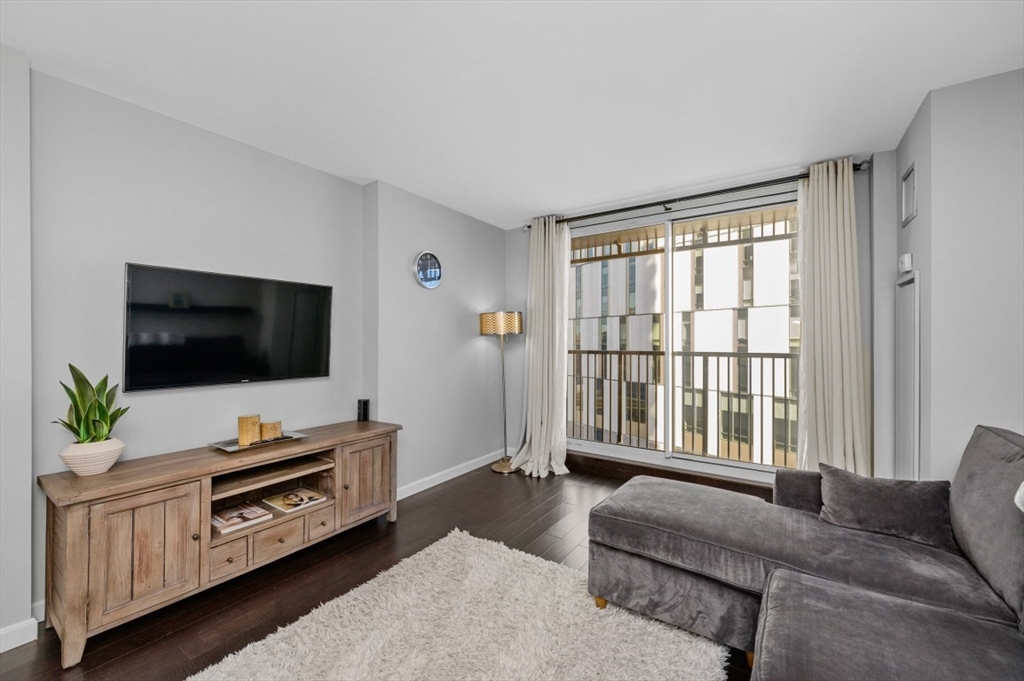 8-12 Museum Way, Unit 828 Cambridge, MA 02141 - Photo 3 of 13 a living room with furniture and a flat screen tv