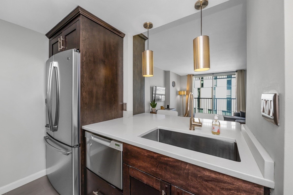 8-12 Museum Way, Unit 828 Cambridge, MA 02141 - Photo 5 of 13 a kitchen with kitchen island a sink stove and refrigerator