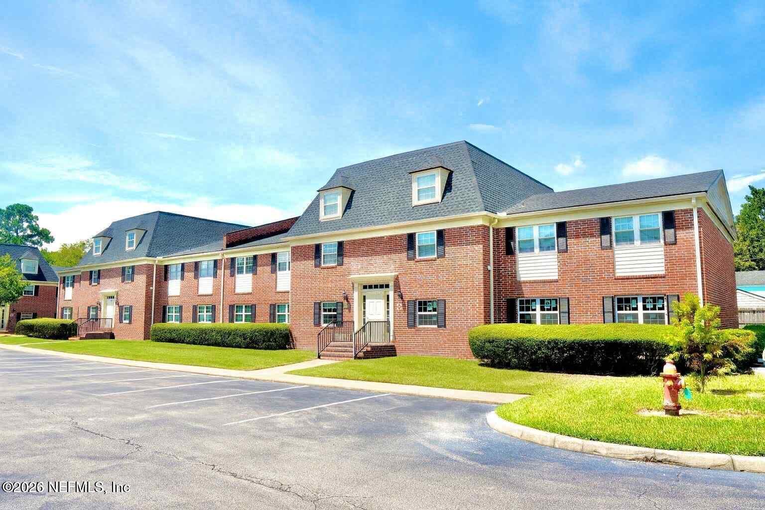 a front view of building with yard