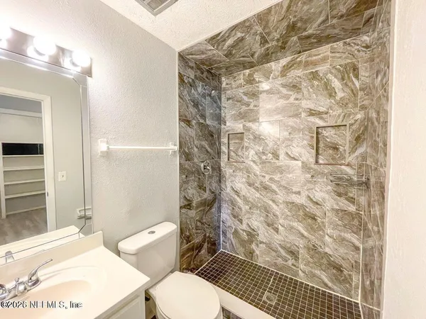 a white toilet sitting next to a bathroom sink