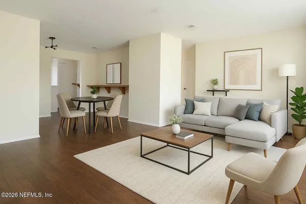 a living room with furniture and a wooden floor