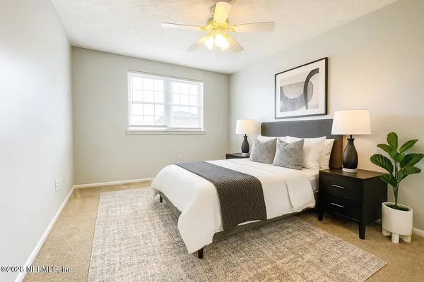 a bed room with a bed and a chandelier