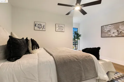 a bedroom with a bed and a painting on the wall